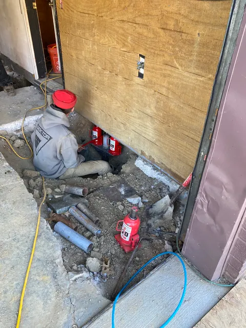 Queen Foundation Repair crew member working on a foundation repair project