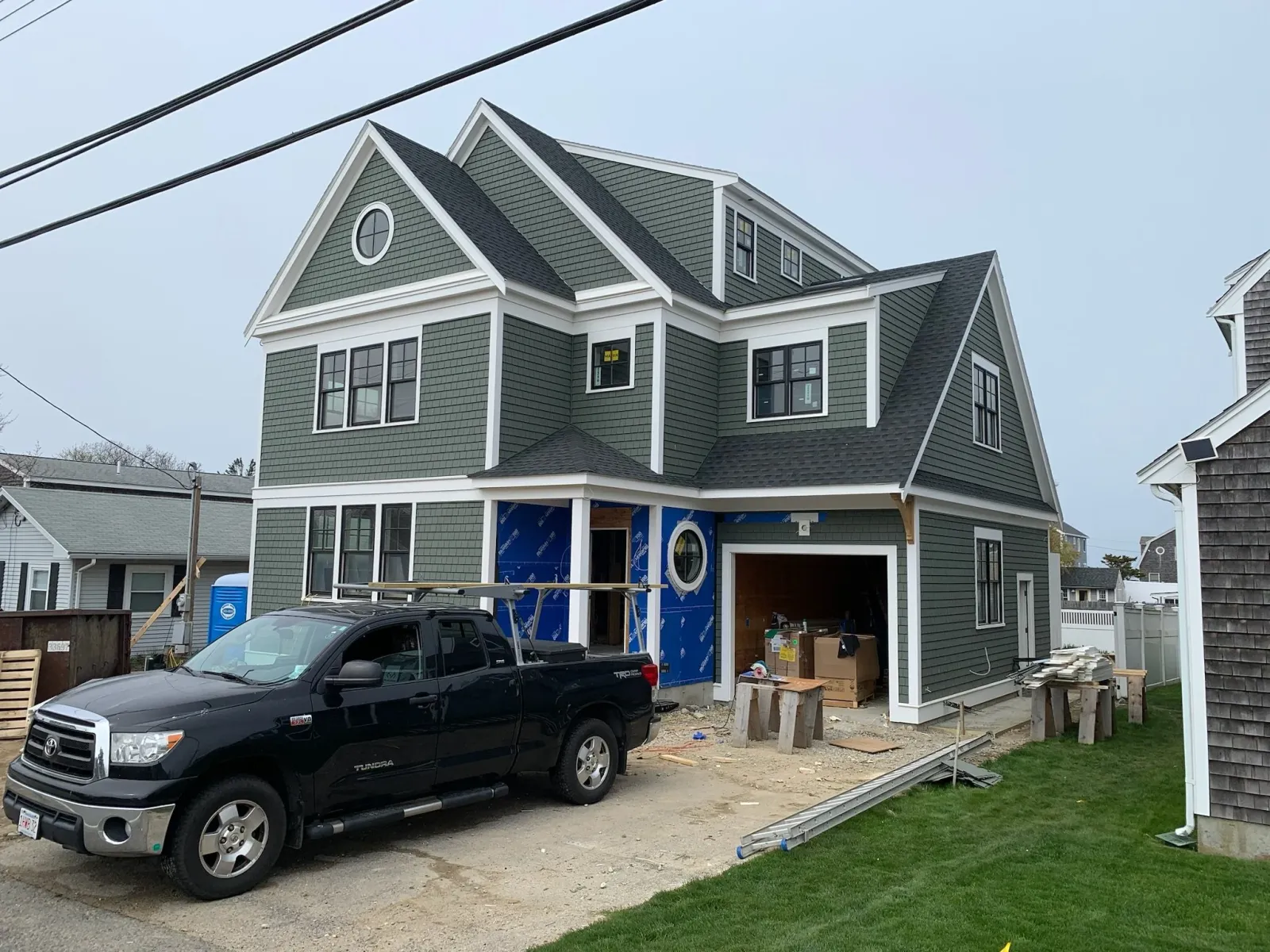 Under construction green multi-story house. It looks amazing.