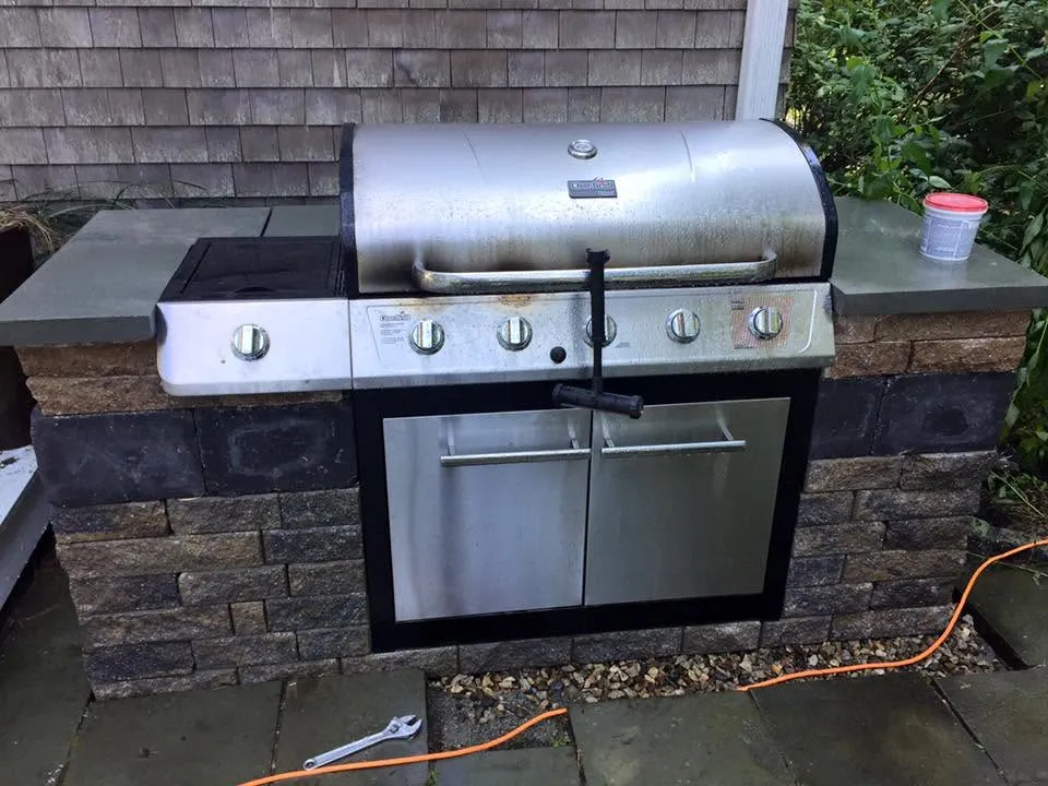 Built-in outdoor kitchen with stone surround
