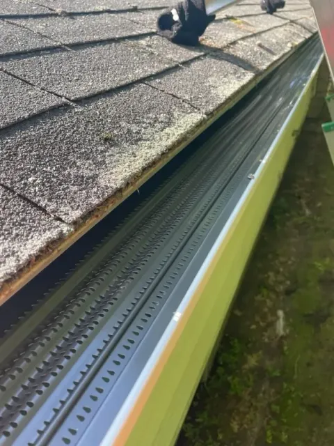 A close up of a gutter on top of a roof.