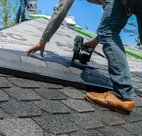 Professional roofing contractors working on a residential home in Meriden Connecticut