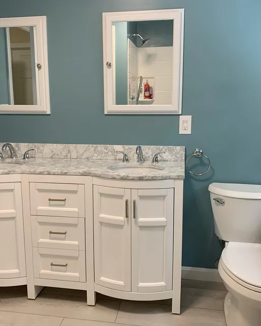Finished bathroom remodel with new vanity, lighting and tile
