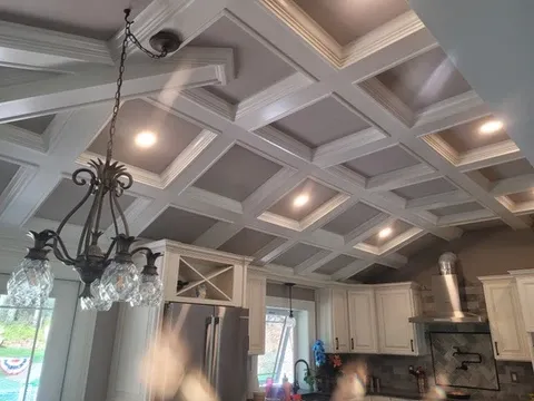 Modern kitchen with white coffered ceiling and chandelier