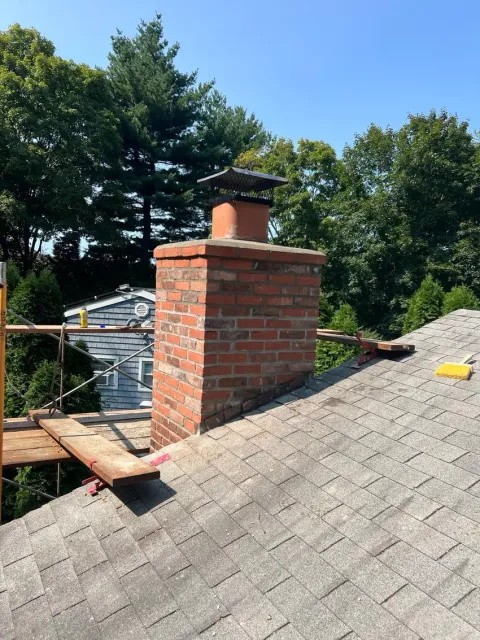 Finished brick chimney with a masonry cap