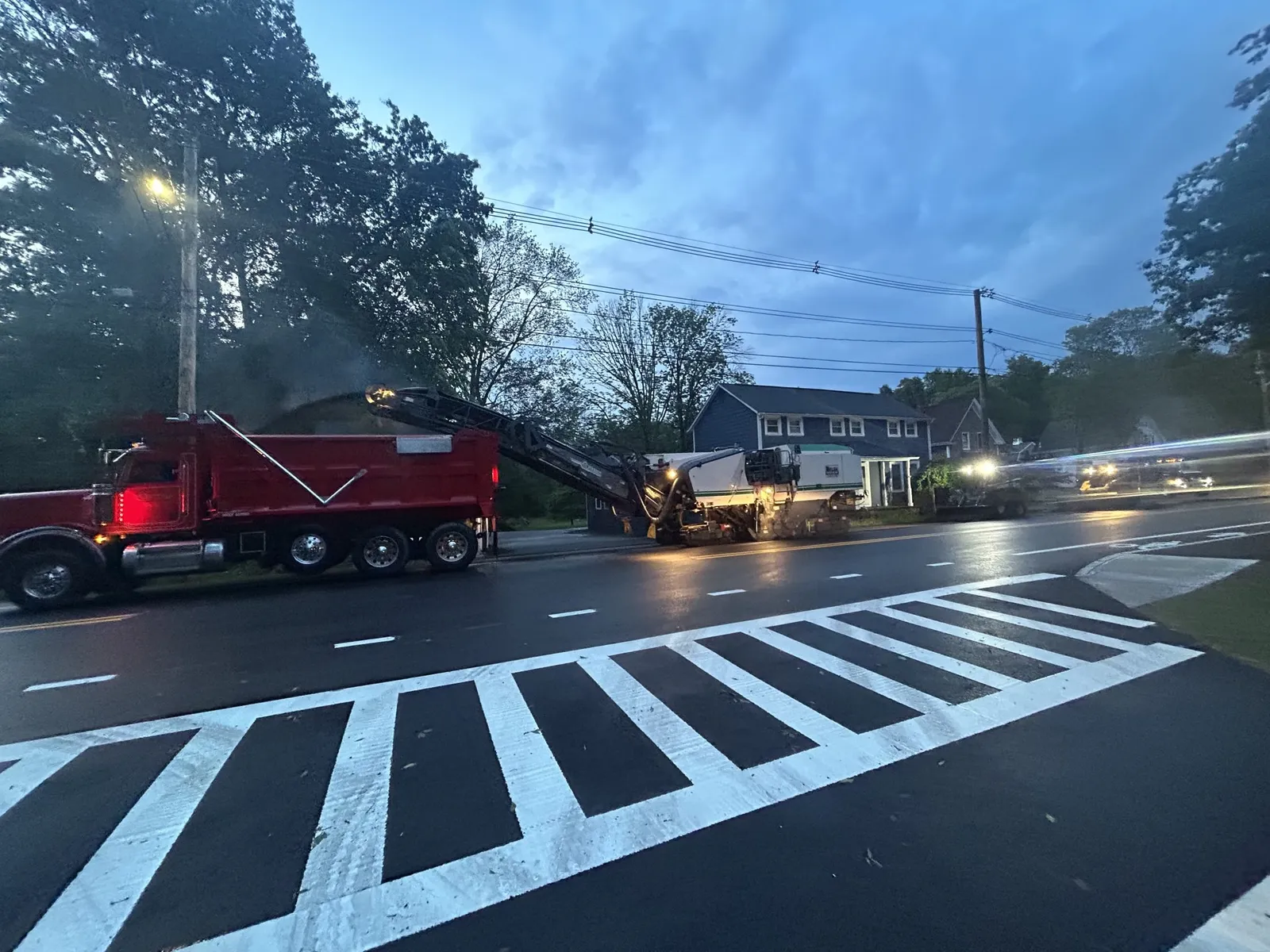 Walsh Contracting Corp performing asphalt milling on a roadway at dusk in preparation for paving and resurfacing.