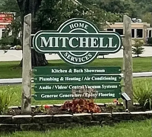 A green sign for mitchell home services