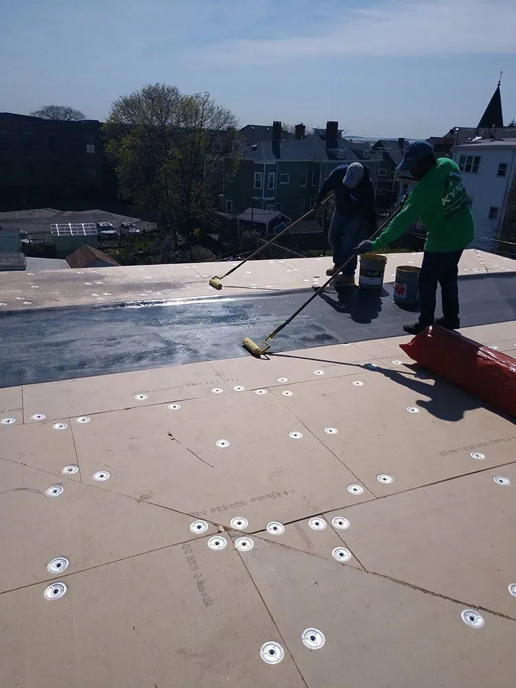 Kyne Roofing & Construction people waterproof coating on roof