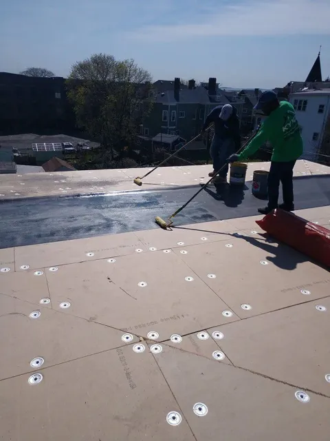 Kyne Roofing & Construction people waterproof coating on roof
