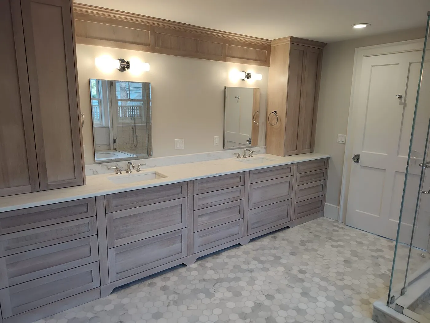 Custom bathroom double vanity with framed mirrors and tile work