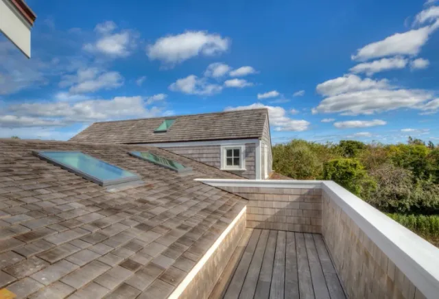 Pool pavilion with white columns, standing-seam metal roof, and ipe decking — Newport, RI