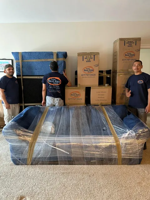 Three Boston Best Rate Movers crew members with packed furniture