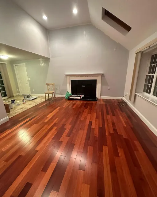 A living room with hardwood floors and a fireplace.