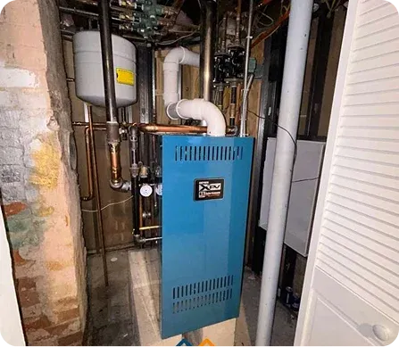 Blue boiler installed in a basement utility closet