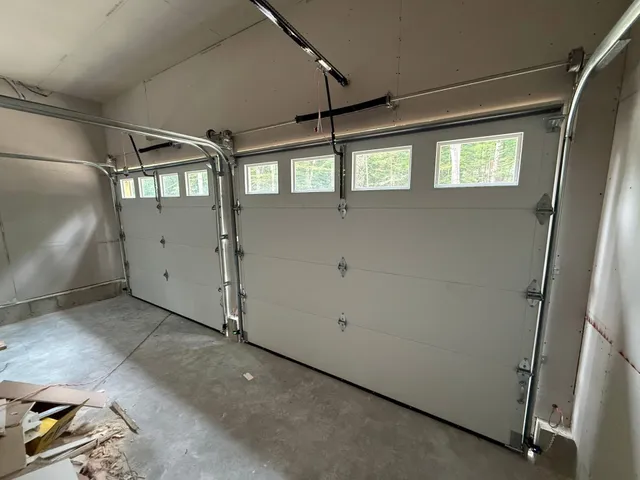 Interior view of newly installed insulated sectional garage doors with window inserts