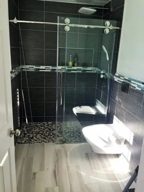 Glass shower enclosure with pebble floor