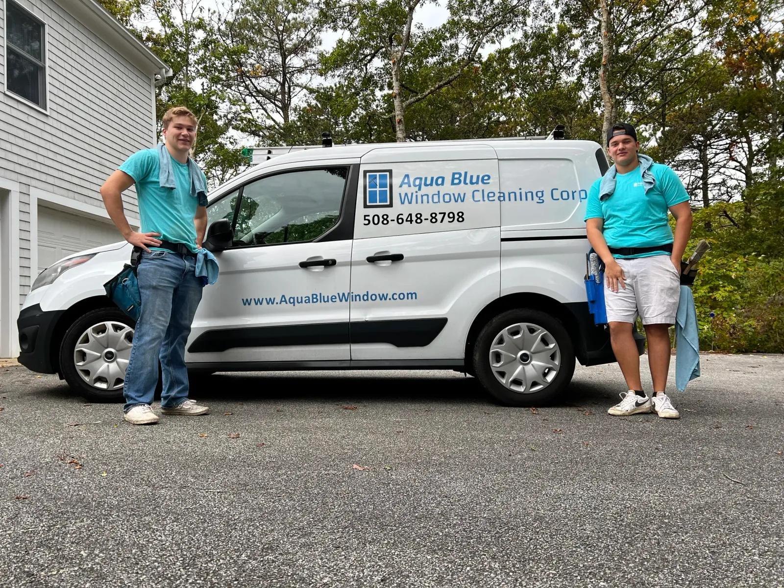 Two team members next to the Aqua Blue Window van
