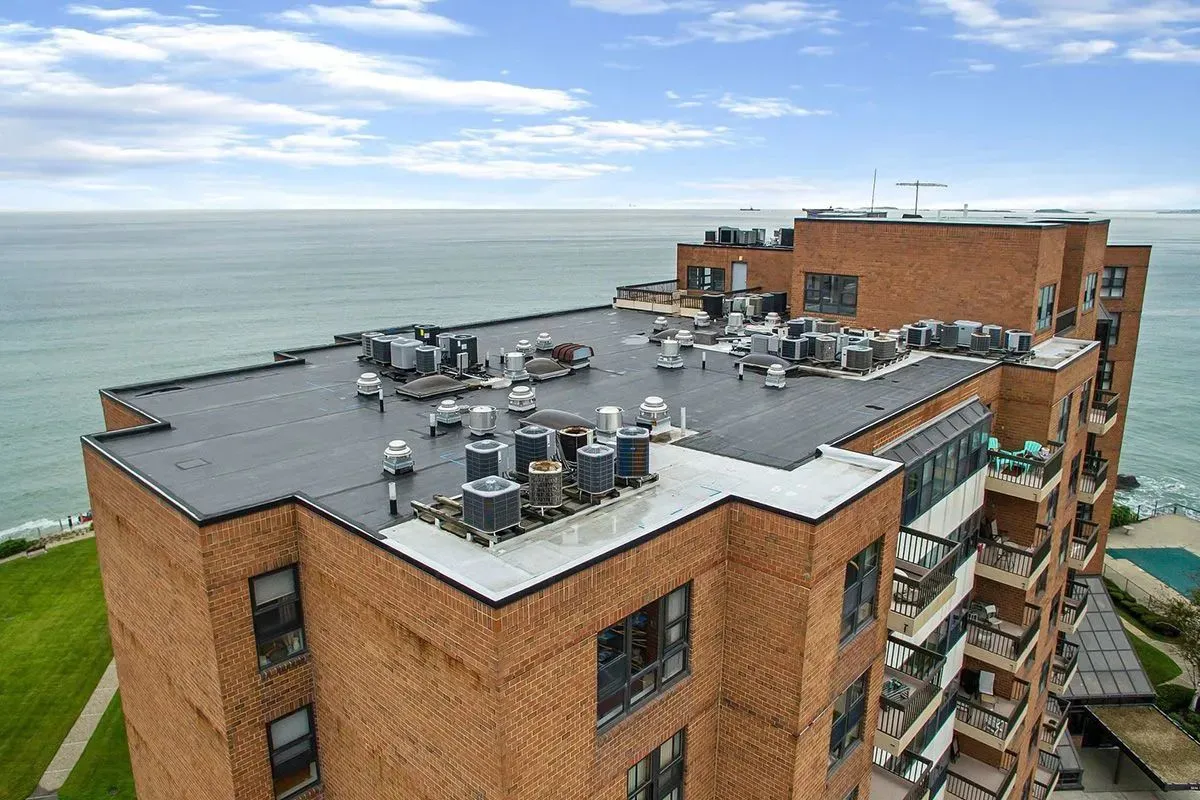 Rooftop mechanical and membrane work overlooking the harbor