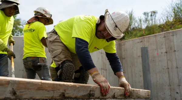 Sweeney, employee pushing concrete leveling, concrete-clarity