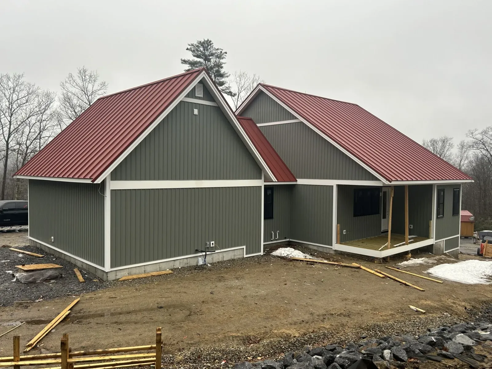 A green house with a red roof is being built