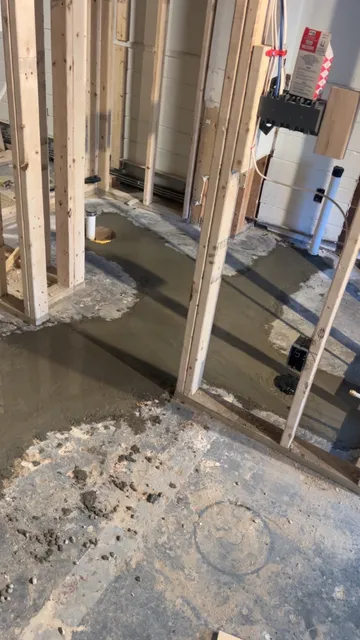 Basement bathroom rough-in with underground drains and fresh concrete
