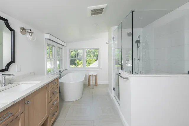 Norwell primary bath with white oak Tedd Wood vanity, freestanding tub, and walk-in glass shower