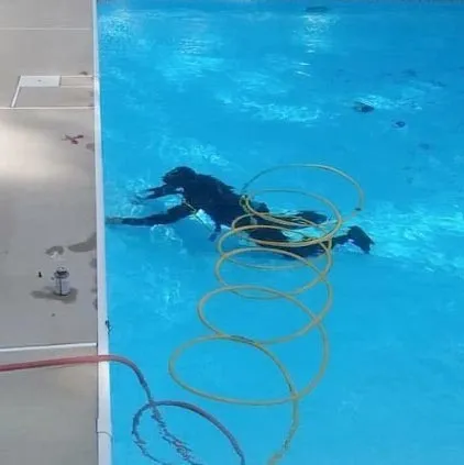 Leak detection specialist underwater with scuba gear