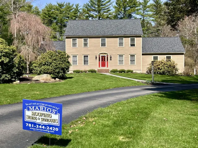 Large two-story Colonial home with tan siding, red front door, and new CertainTeed Landmark Pro Moire Black roof in Lakeville, MA