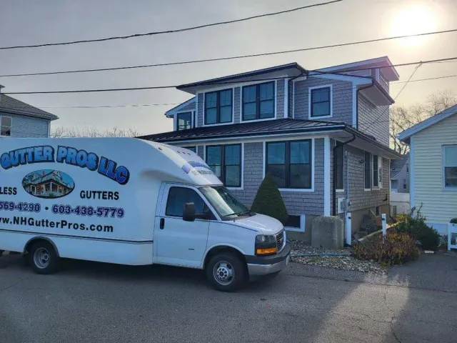 A white van is parked in front of a house.