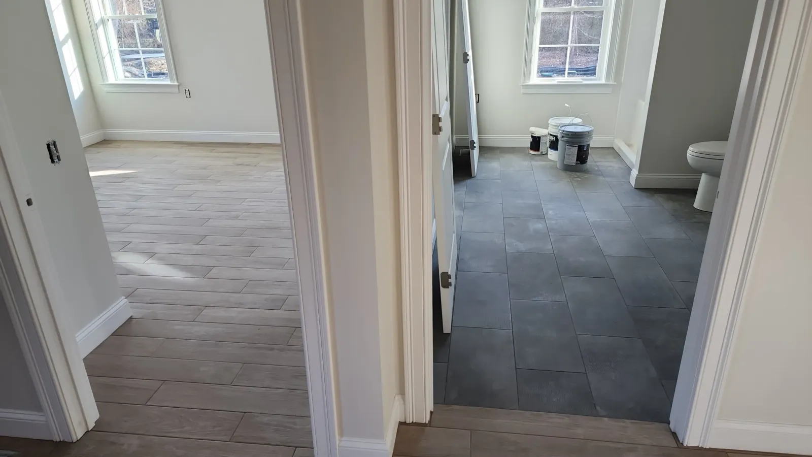 Finished dark tile floor extending through a hallway