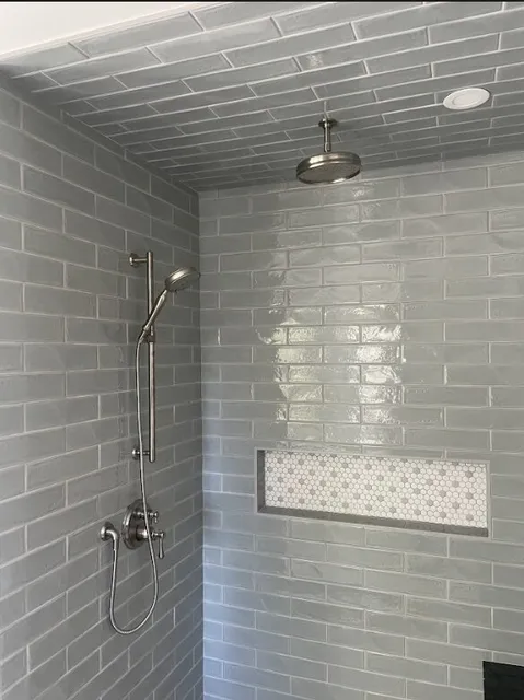 New wetwall system installed with walk-in shower and brushed nickel fixtures