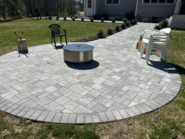 There is a fire pit in the middle of the patio.