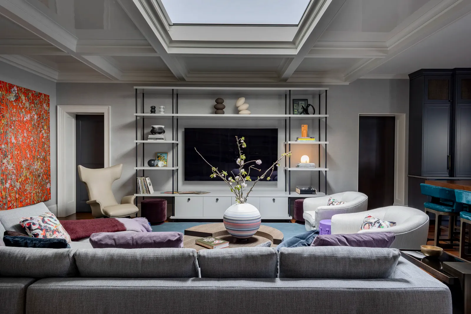 Penthouse living room with coffered ceiling and built-ins
