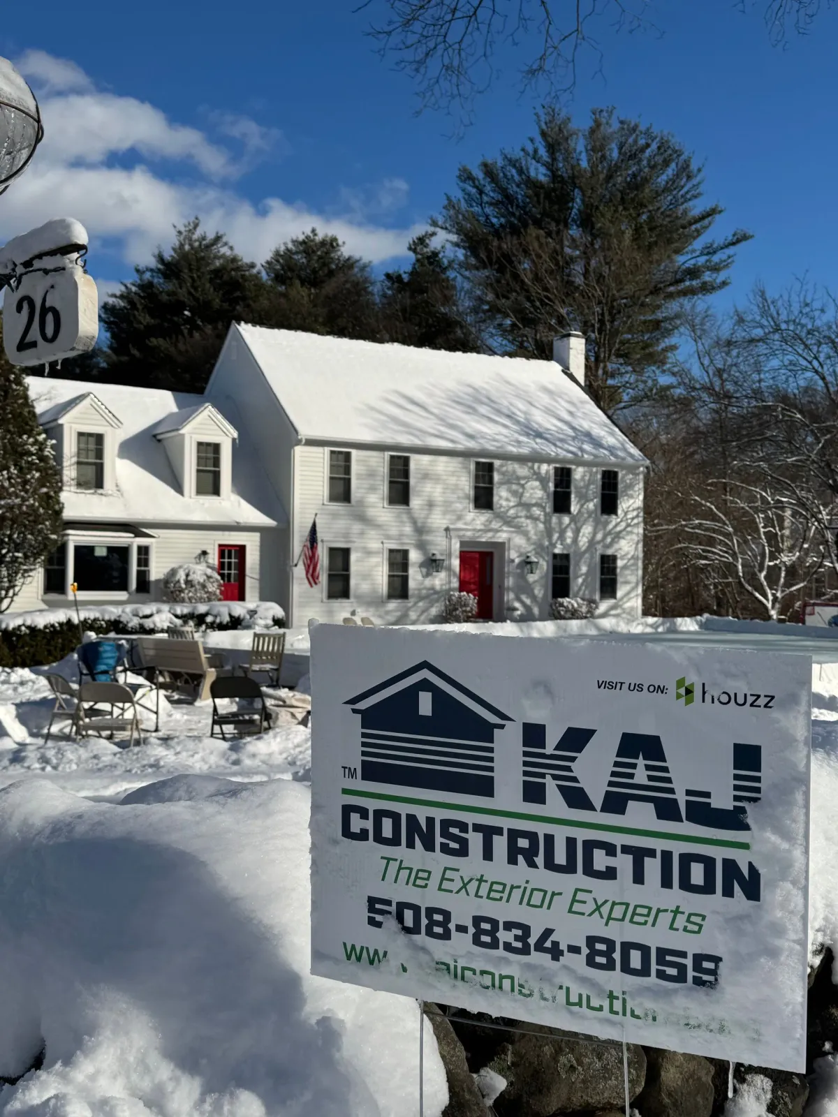 A white house with a construction sign in front of it