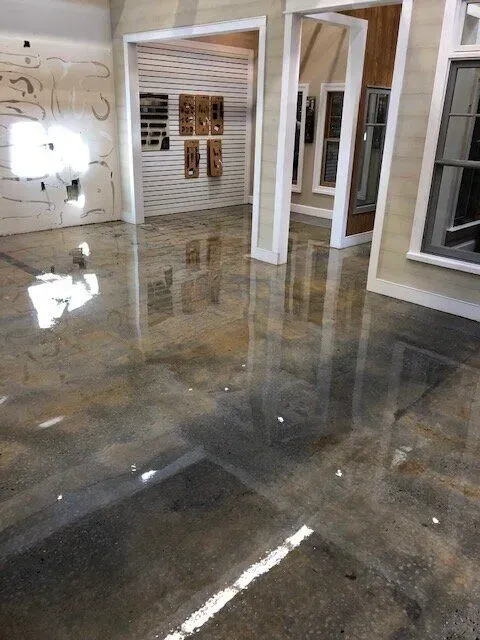 A room with a shiny floor and a reflection of windows