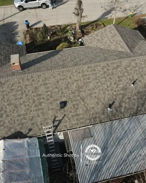 Roofing and siding exterior renovation nearing completion on a residential property.