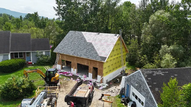 New construction roof installation Hinesburg Vermont with Vermont mountains — Rivers Construction