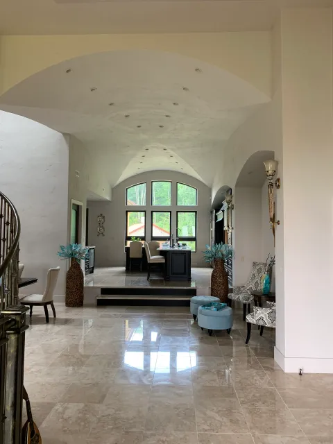 A large living room with a staircase leading up to the second floor.