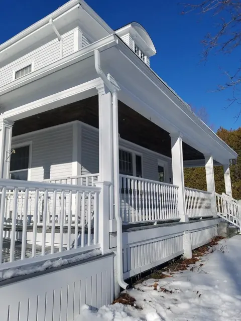 Covered porch with white gutter system