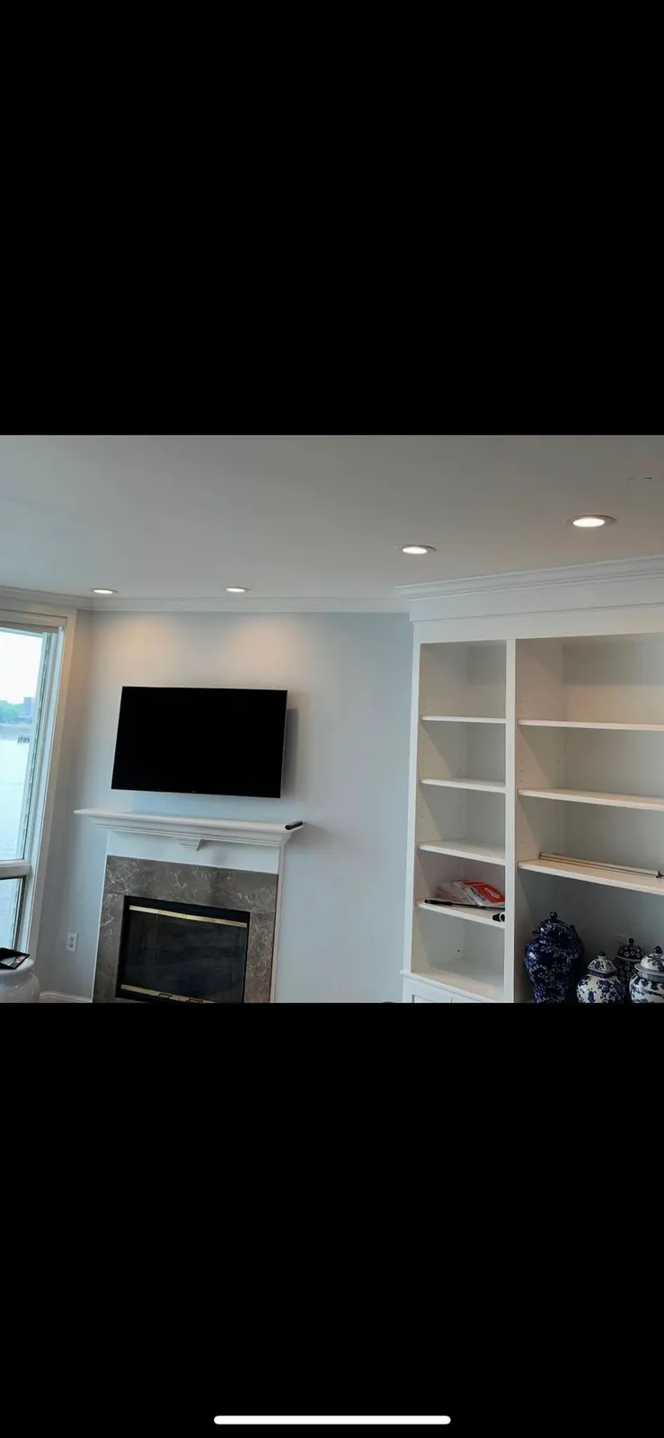 Built-in cabinetry with wired TV and fireplace