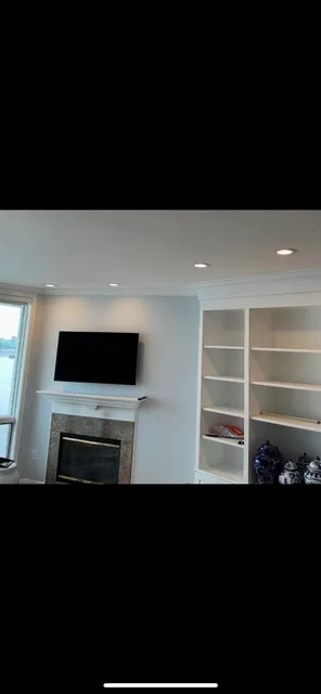 Built-in cabinetry with wired TV and fireplace