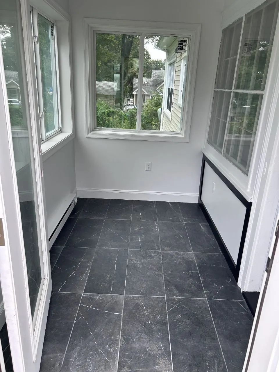 Inside the finished addition: tile floor, new windows and trim
