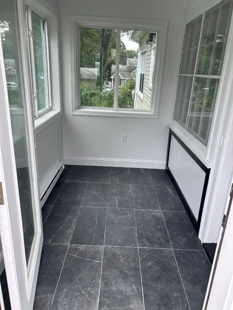 Inside the finished addition: tile floor, new windows and trim