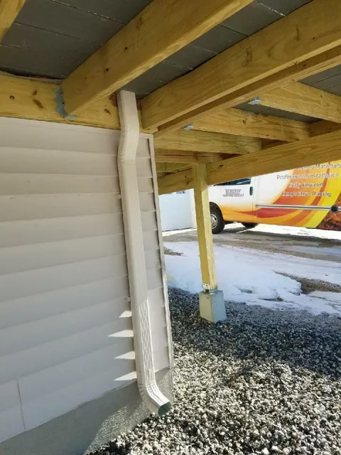 Downspout beneath elevated deck