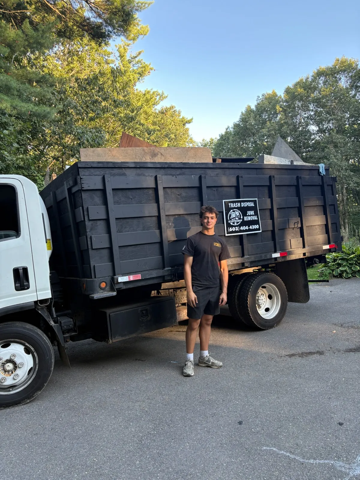 EasyScrap Team Member In Front Of Black Junk Truck