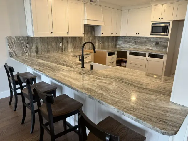 Granite kitchen island with bar seating — countertop project for a New Hampshire builder by Precision Granite Works