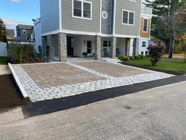 A large house with a large driveway in front of it.