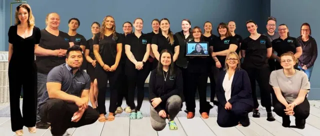 Group photo of the Maid For You NH team, smiling and gathered together for a group photo