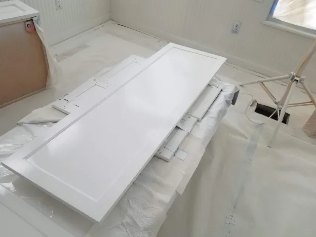 Kitchen cabinet spray refinishing using Benjamin Moore Advance Satin Finish paint