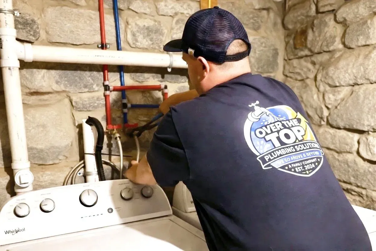 Over the Top Plumbing Solutions plumber working on plumbing for a residential home improvement project.