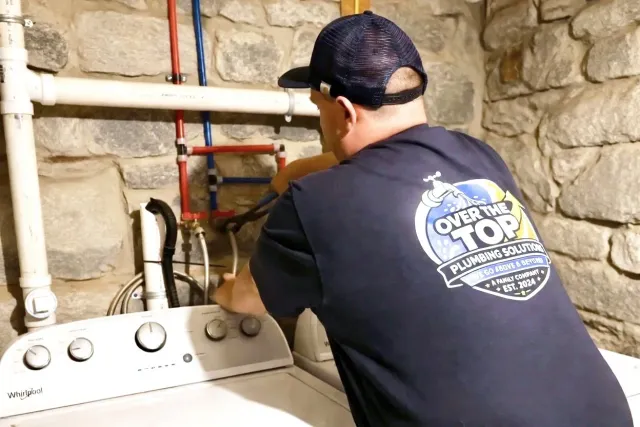 Over the Top Plumbing Solutions plumber working on plumbing for a residential home improvement project.